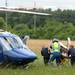 Huron Valley Ambulance personnel and University of Michigan Survival Flight crew wheel an injured man to a helicopter in a field at the corner of Miller and W. Delhi May 31 after he was pinned underneath a tree at a nearby address. Melanie Maxwell I AnnArbor.com